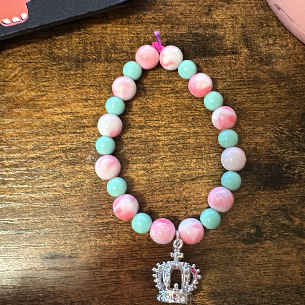 Pink marble and teal bracket with crown charm
